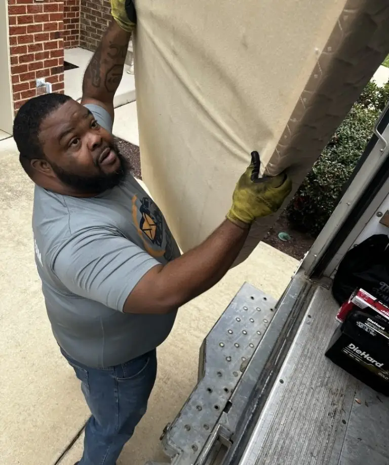 Envelop by McClain team member loading items during a professional junk removal service